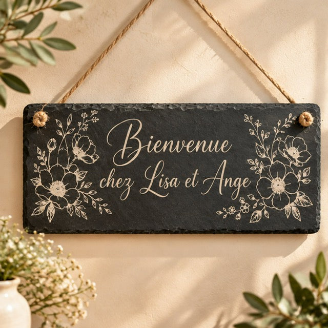 Pancarte en ardoise gravée Bienvenue avec prénoms avec décor floral, suspendue à une cordelette en jute
